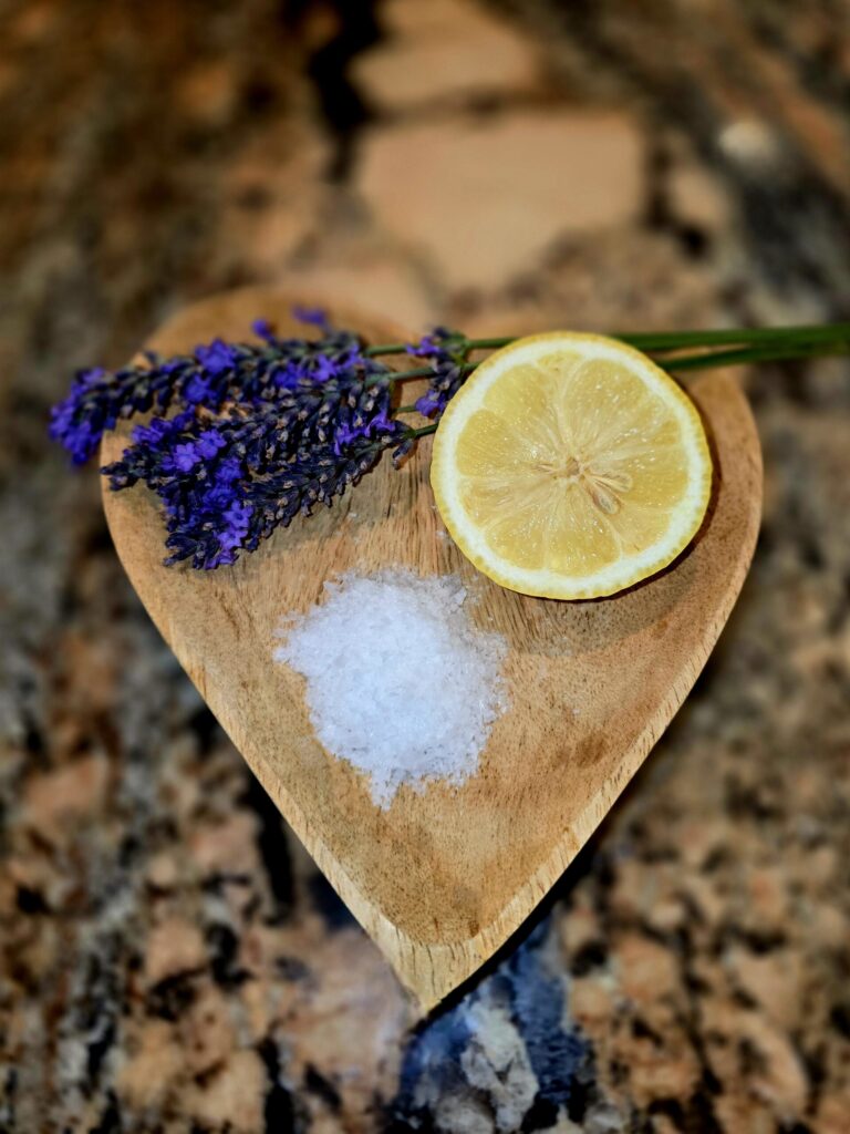 Natural wood heart bowl with lavender, sea salt and lemon representing clean living pets and non-toxic home solutions